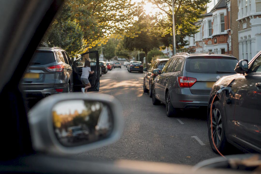 Narrow street with parked cars and door hazards