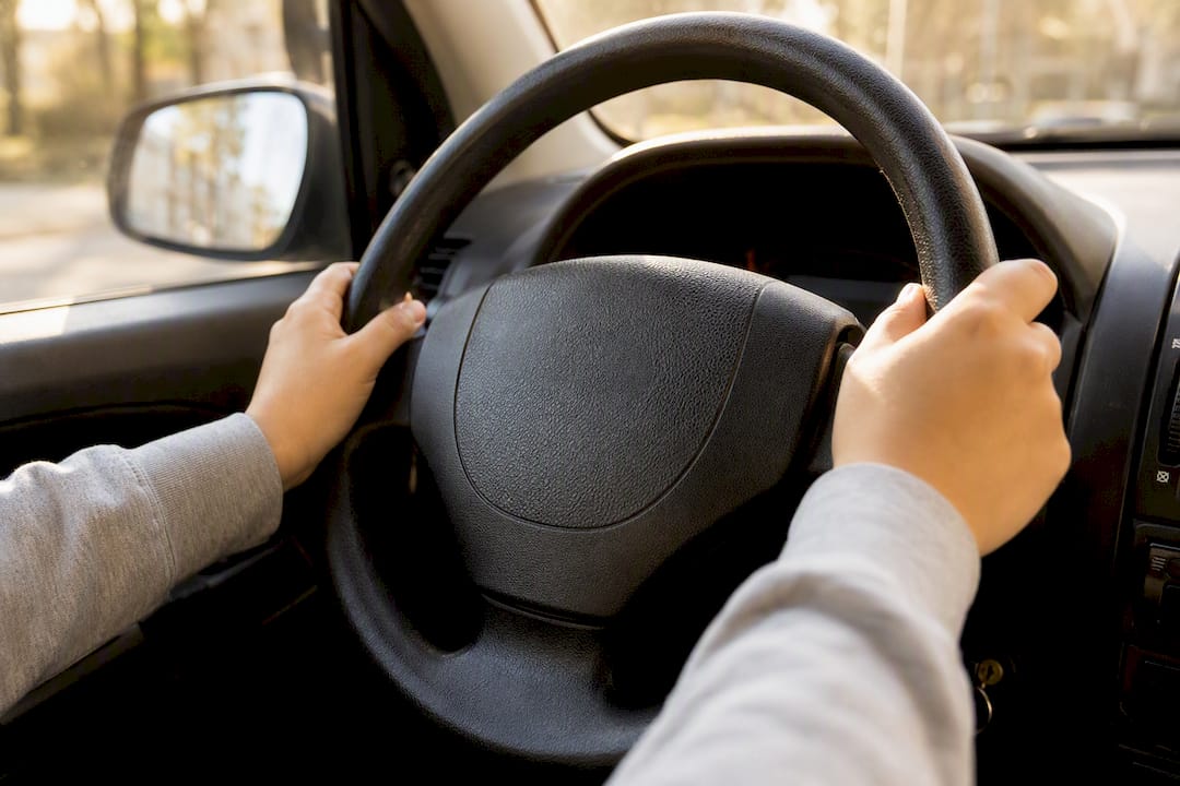 Hands holding steering wheel correctly