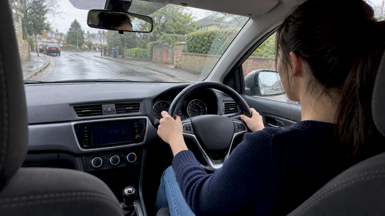 DVSA Backed Steering Control: Instructor Playbook for UK Learners 1 Learner car steering gently on wet road